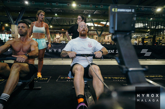 Athletes competing in a HYROX event performing functional workouts