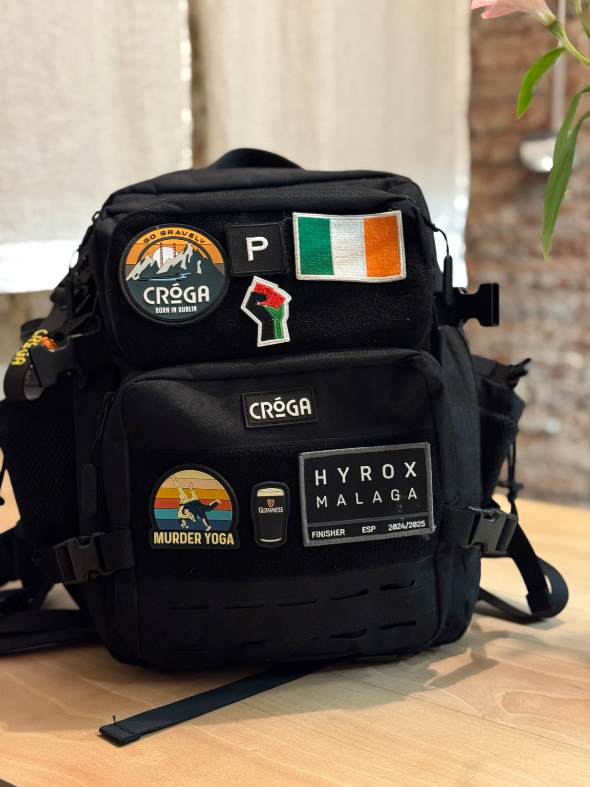 Nomad 25L Carbon Black backpack personalised with travel patches