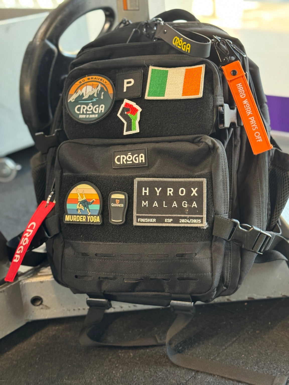 Nomad 25L Carbon Black backpack with patches inside a vehicle